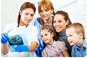 Mother and Children Viewing X-Rays with Dental Technician