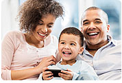 Father, Mother and Young Child Viewing Smartphone