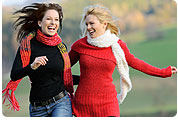 2 Smiling Women Walking Together